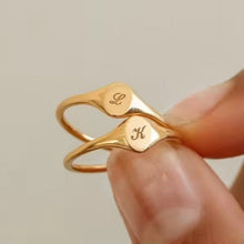 Load image into Gallery viewer, Gold ring with engraved initials held by a hand against a neutral background