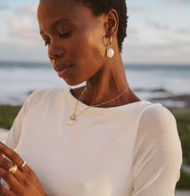 Load image into Gallery viewer, Woman wearing gold pearl jewelry 